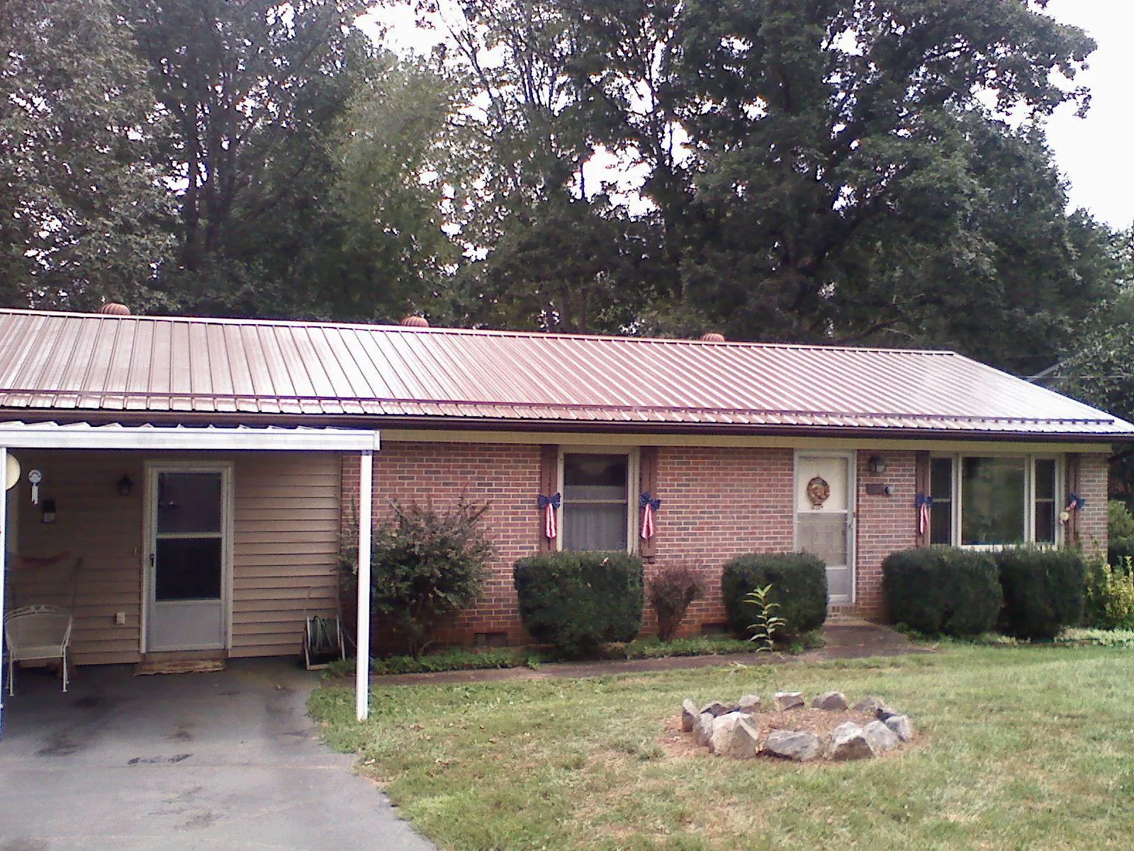 Bronze metal roof and carport on a brick ranch home — Roof Repair work by our crew in Island Heights
