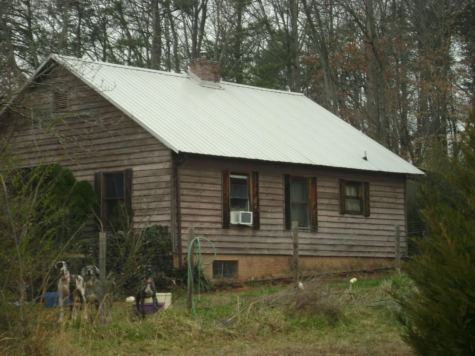 White metal roof on an old wood sided farmhouse, from a Metal Roof Installation job in Island Heights